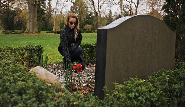 istock Young woman grieving at graveyard 493831897