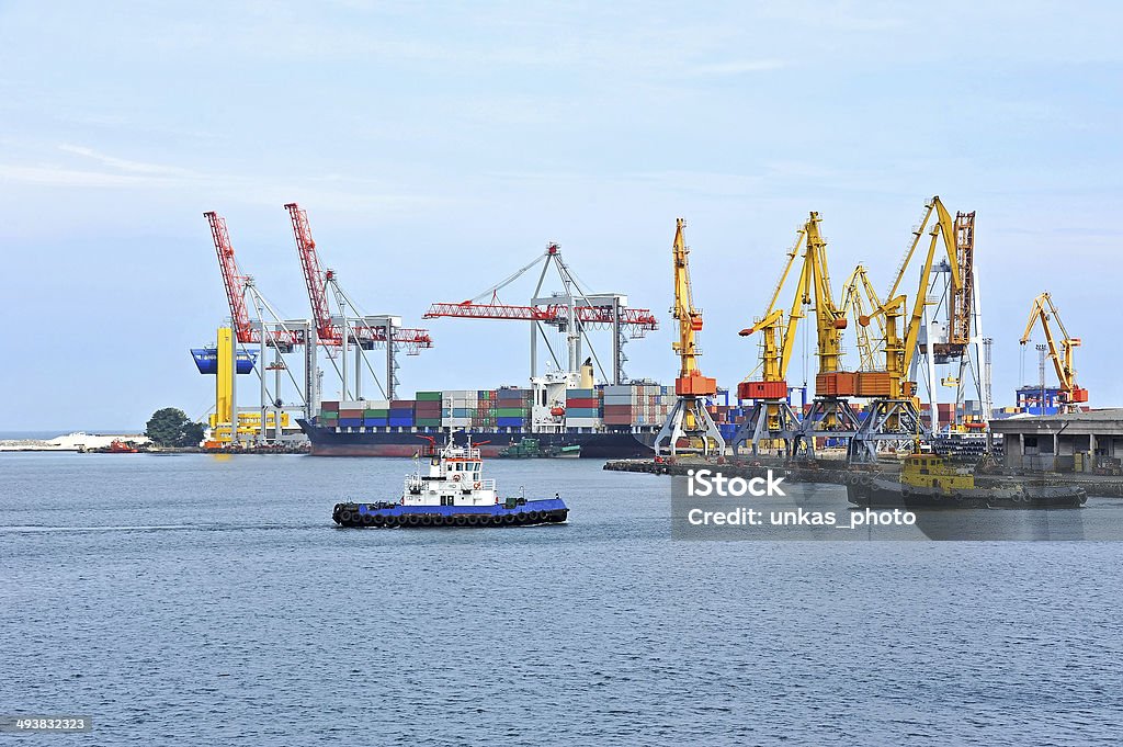 Tugboat assisting container cargo ship Tugboat assisting container cargo ship to harbor quayside Assistance Stock Photo