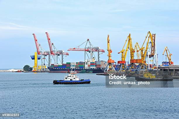 Tugboat Assisting Container Cargo Ship Stock Photo - Download Image Now - Assistance, Blue, Business