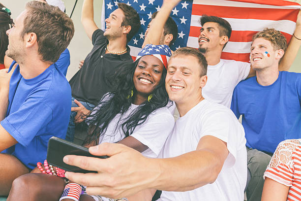 istock American Supporters taking Selfie at Stadium 493833025