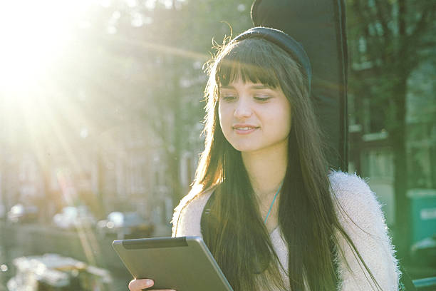 istock Portrait Of A Cheerful Young Woman Using Digital Tablet 493833962