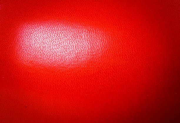 Close up Side of Boxing Gloves Red Leather Skin for Wallpaper texture background Isolated on white background.