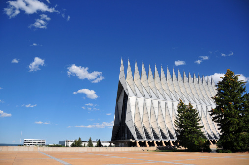 Colorado Springs, Colorado, USA: United States Air Force Academy Cadet Chapel - East side view with campus buildings in the backgrounnd - The chapel contains a 1,300 seat Protestant chapel, a 500-seat Catholic chapel, a 100-seat Jewish synagogue, as well as interfaith rooms for cadets of other religions - modernist architecture by Walter Netschof Skidmore, Owings and Merrill - photo by M.Torres