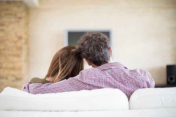 istock Young couple watching tv 493835792