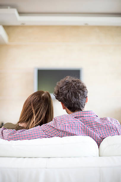 istock Young couple watching tv 493835846