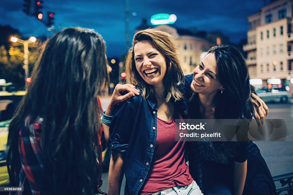 Smiling woman outdoors at night Happy young women kn the city at night. Night Stock Photo