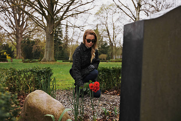 istock Paying her respect to deceased family member 493836199
