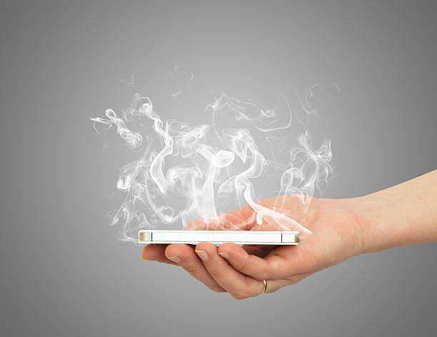 istock Hand holding smart phone with white smoke 493836957