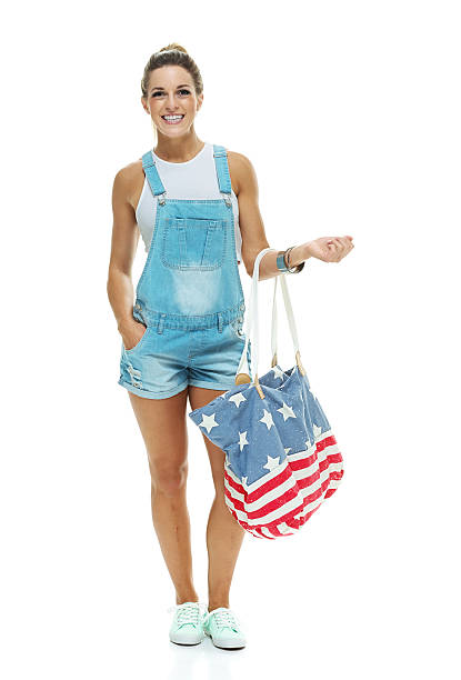 istock Cheerful woman holding handbag 493838612
