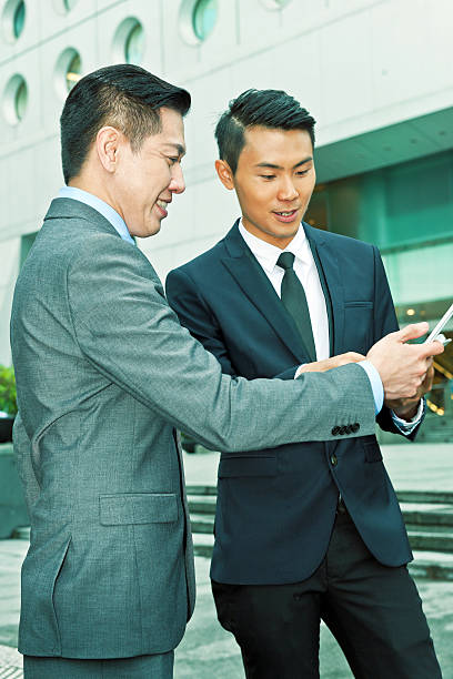 istock Asian Business Associates Using Mobile Devices, Hong Kong, China 493848967