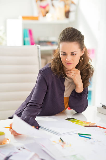 istock fashion designer working in office 493849219