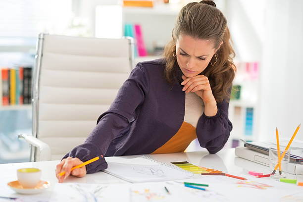 istock thoughtful fashion designer working in office 493849225