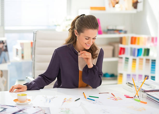 istock happy fashion designer working in office 493849233