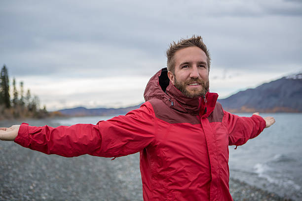 istock Cheerful man in nature arms outstretched for positive emotion 493856362