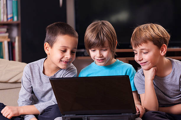 istock Cute little boys playing with laptop 493856452