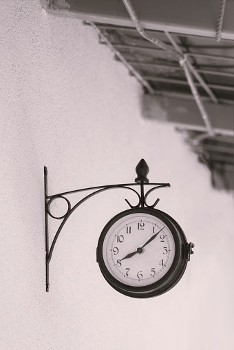 beautiful old retro watch on the outdoor wall showing eight hour