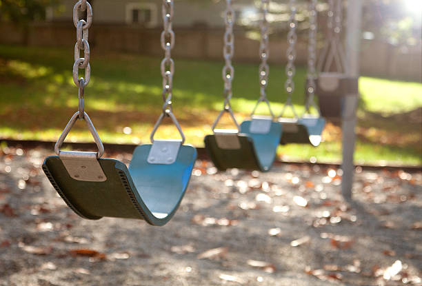 istock Empty swings on a playground in autumn 493857980