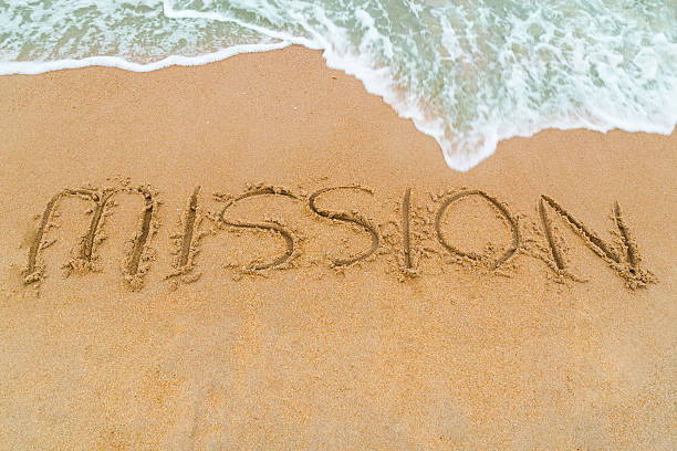 istock MISSION inscription written on sandy beach with wave approaching 493858012