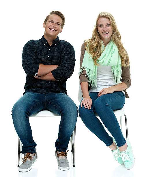 istock Smiling couple sitting and looking at camera 493858120
