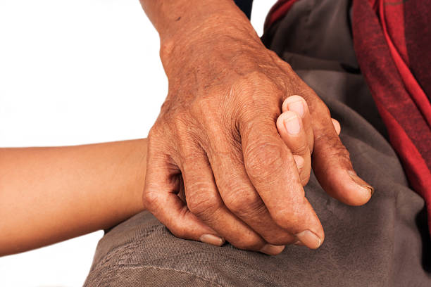 istock boy hand touches and holds an old man wrinkled 493859824
