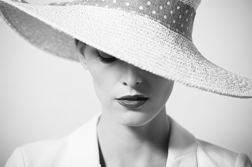 Portrait of beautiful young woman with hat. Fashion concept.