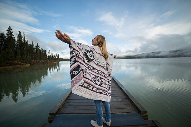 istock Young serene woman relaxing by the lake 493863064
