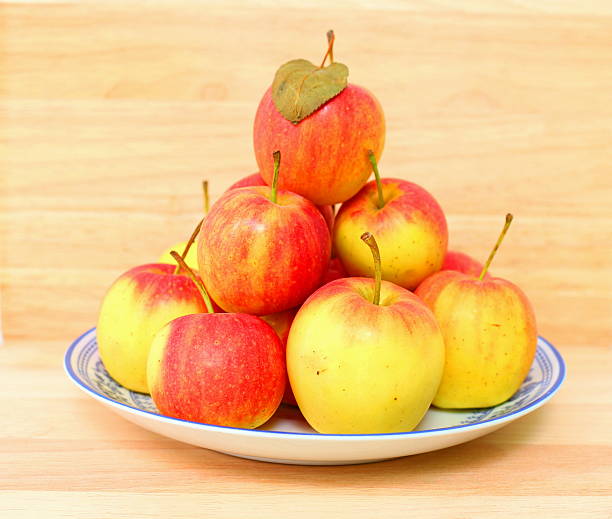 istock Crab apples on porcelain dish with wooden background. 493866290
