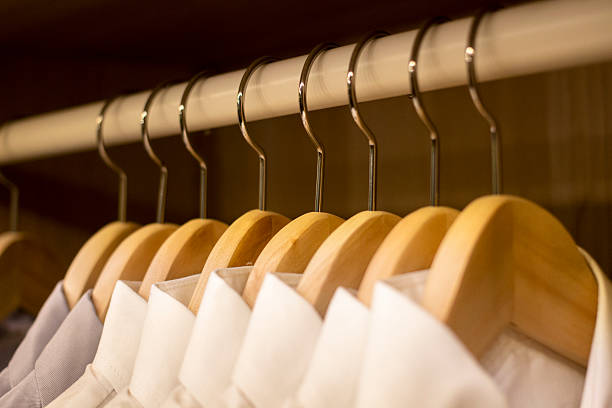 istock shirts hanging in clothing closet 493868532