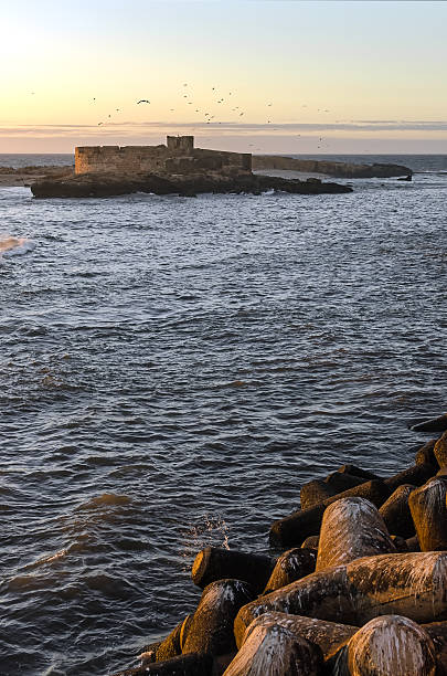 istock Castle in the ocean at sunset 493868620