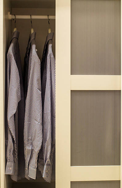 istock shirts hanging in clothing closet 493868648