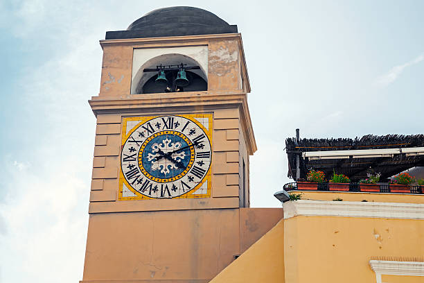 Clocktower on Piazza Umberto I, the most famous square of the island of Capri, Italy. Vintage stylized photo with warm tonal correction filter