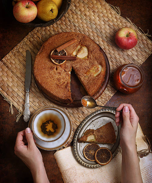 istock Female hands holding tea and spoon with jam 493868874