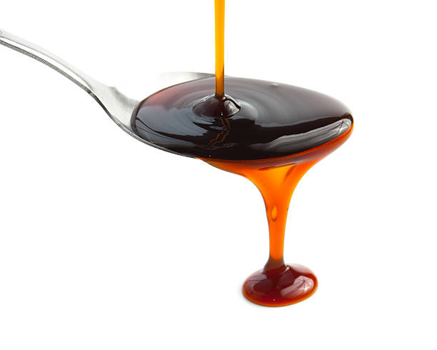 istock Pouring Soy Sauce on spoon isolated on white 493870582