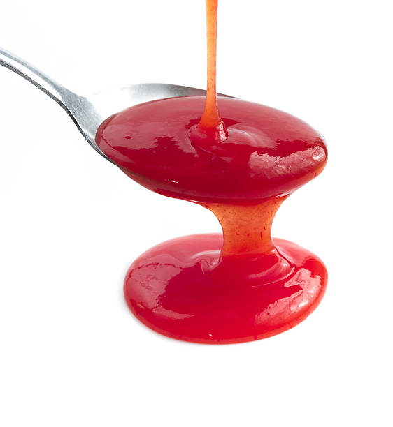istock Tomato Ketchup Or Red Sauce on spoon isolated on white 493871314
