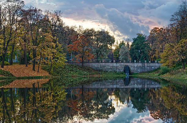 Autumn lake with stone bridge at evening stock photo