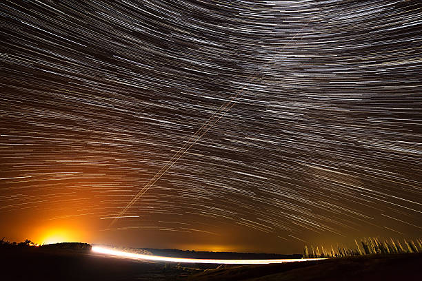 istock Star trail on highway illuminated light vehicles. 493881176