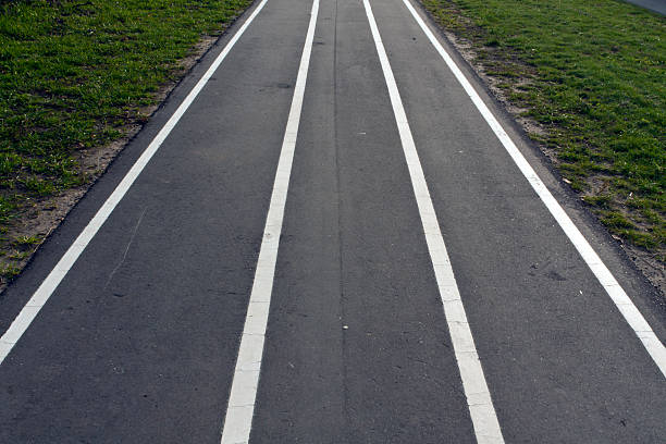 istock Running asphalt track with white painted lines. 493881272