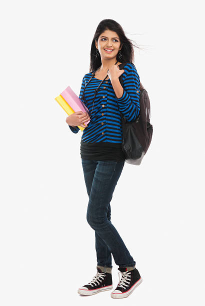 Female university student holding books and smiling