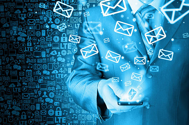 istock Business man holding smart phone and sending emails 493882421