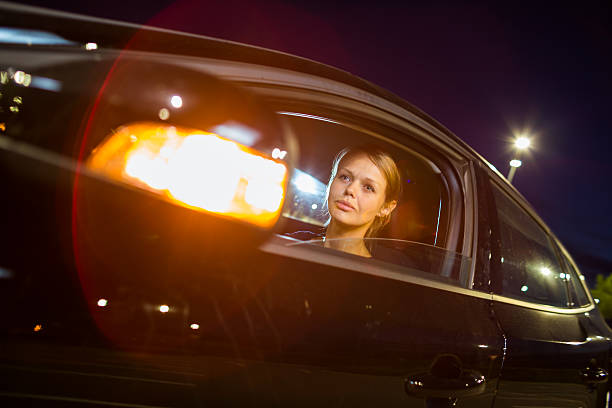 istock Woman driving a car at night 493882843