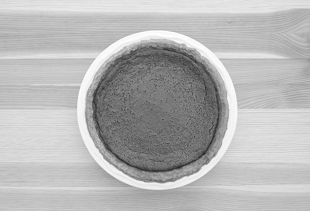 Freshly baked homemade pumpkin pie for Thanksgiving on a kitchen table - monochrome processing