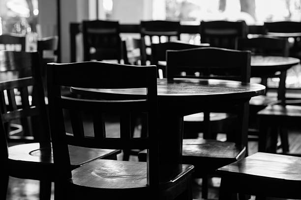 istock black & white of empty tables and chiar 493882983