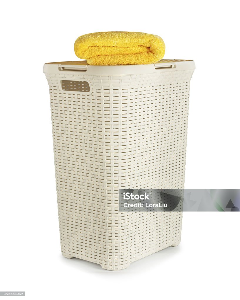 Terry towels in a laundry basket isolated on white background Basket Stock Photo