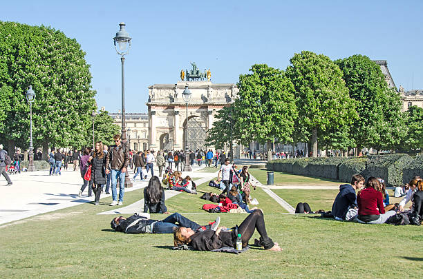 Paris, France - April 16, 2014: In a park near the Louvre, a crowded walking area the week before Easter.Most of the people are tourists and visitors to the Louvre.
