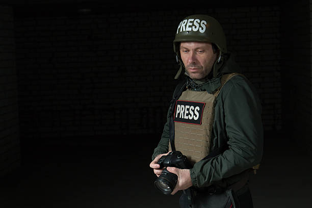 istock Photojournalist in a helmet and flak jacket 493884368