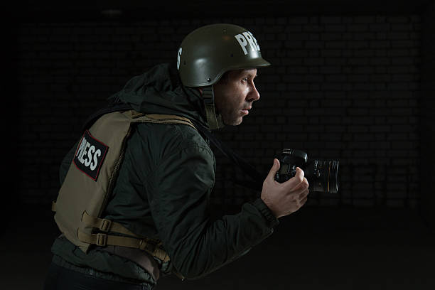 istock Photojournalist in a helmet and flak jacket 493884444