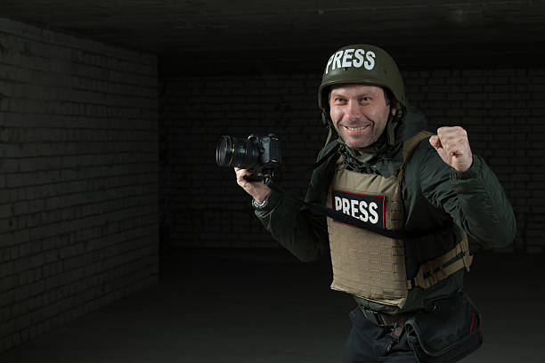 istock Photojournalist in a helmet and flak jacket 493884468
