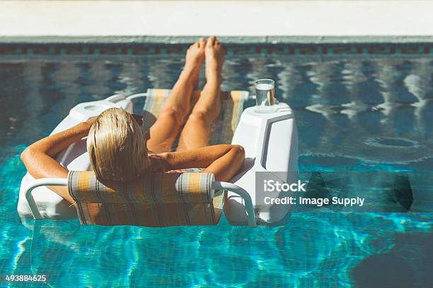 Blonde Woman Relaxing In Pool Stock Photo - Download Image Now - Adult, Beauty, Bikini