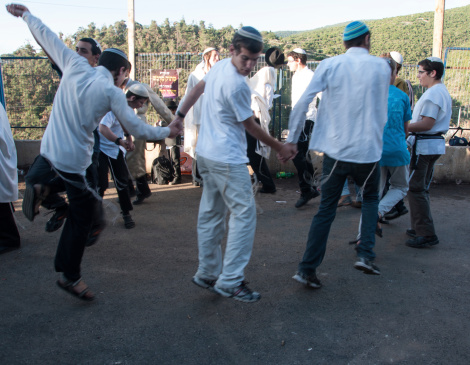 Meron, Israel - May 18, 2014: Orthodox Jews dance at the annual hillulah of Rabbi Shimon Bar Yochai, in Meron, on Lag BaOmer Holiday. This is an annual celebration at the tomb of Rabbi Shimon