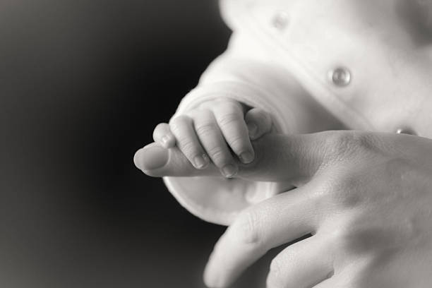 istock baby and adult hands 493885848
